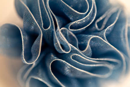 Macro photo of a Christmas chiffon bow. Ribbon fabric close up. Mesh