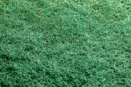 The surface of the threads. Interlacing of green threads. Surface of plastic green sponge. Scourer...