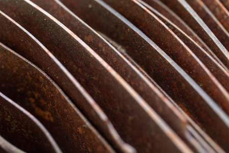 Picturesque curved sheets of rusty metal. Curved rusty sheets of metal. Industrial abstraction. Abstract corroded colorful rusty metal background, rusty metal texture.の写真素材