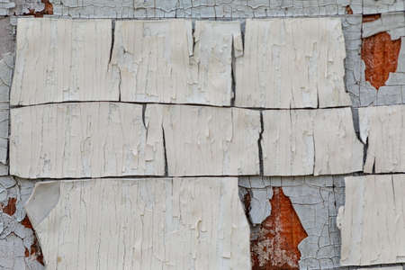Multilayer paint. Peeling paint on a wooden surface. Cracked old paint on a wooden wall. Texture of...