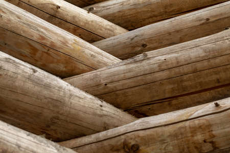 Russian log house. Fragment of the log wall. Wooden background. Wooden logs wall of rural house.の写真素材