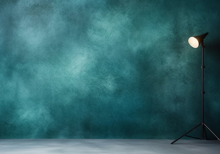 Empty studio with light, textured green wall and gray floor. Interior for mockups. Portrait backdrop for studio.の素材