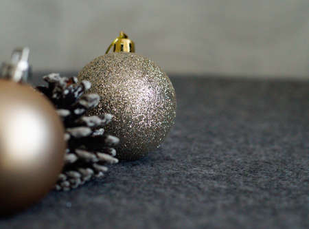 Golden sparkling Christmas decoration close up on grey backgroundの写真素材