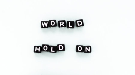World hold on slogan in black block letter beads on white background. Motivation peace conceptの写真素材