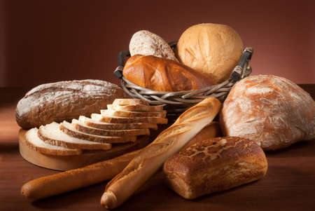still-life assortment of baked bread over brown backgroundの写真素材