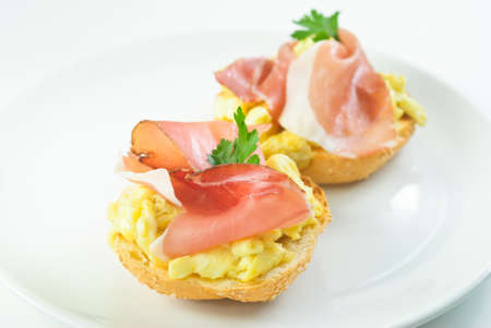 Ham and scrambled eggs sandwich on a plateの写真素材