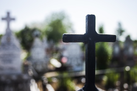 Black iron cross with white cross in background