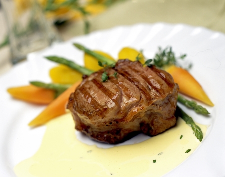 Grilled steak with vegetables in cream sauceの写真素材