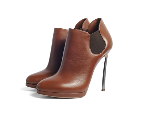 Luxury brown female leather heeled shoes with metal hills isolated on white backgroundの写真素材