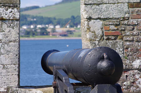 Ancient cannon pointed towards the blue mediterranean sea over the castle of Santa Barbara in Alicante, Spainのeditorial素材