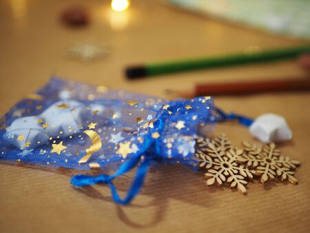 Christmas decoration on wooden background, moon and stars on a blue backgroundの写真素材