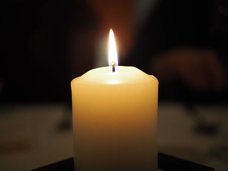 Burning candle in the dark, in resturantの写真素材