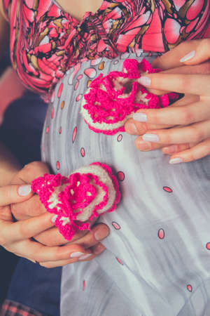 Pregnant belly, lovers armsの写真素材