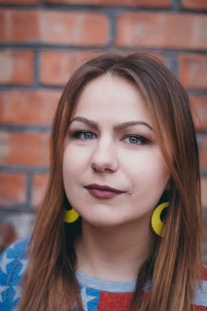 A hipster girl in an old courtyard posing and smilingの写真素材