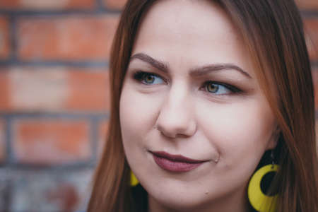 A hipster girl in an old courtyard posing and smilingの写真素材