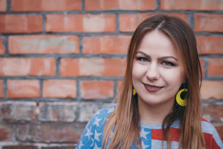 A hipster girl in an old courtyard posing and smilingの写真素材