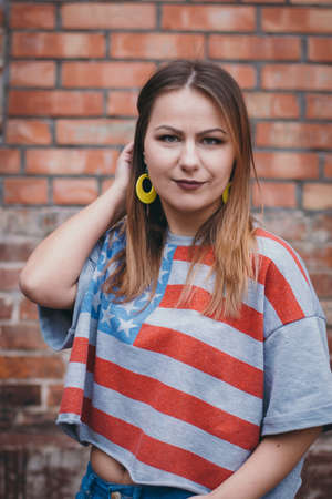 A hipster girl in an old courtyard posing and smilingの写真素材