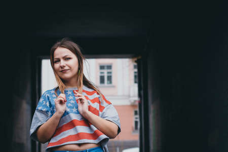 A hipster girl in an old courtyard posing and smilingの写真素材