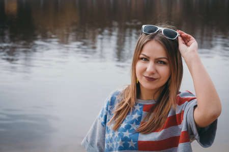A girl hippy on the river bank posing and smilingの写真素材