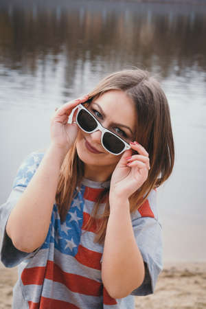 A girl hippy on the river bank posing and smilingの写真素材