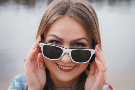A girl hippy on the river bank posing and smilingの写真素材