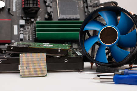 Computer assembly details and tools on a white backgroundの写真素材