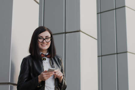 Modern business, woman near the office ponders business planの写真素材