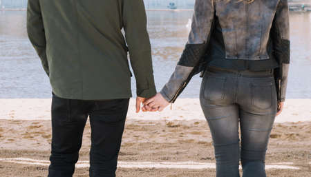 Cheerful loving each other couple kisses. Walk on the river bank and embraceの写真素材