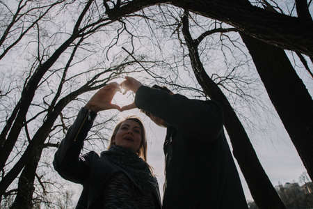Cheerful loving each other couple kisses. Walk on the river bank and embraceの写真素材
