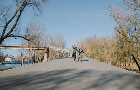 Cheerful loving each other couple kisses. Walk in the park and hug.の写真素材