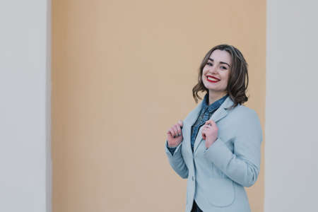 Portrait of a happy enamored girl in anticipation of a beloved man in the parkの写真素材