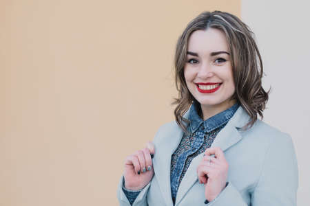 Portrait of a happy enamored girl in anticipation of a beloved man in the parkの写真素材