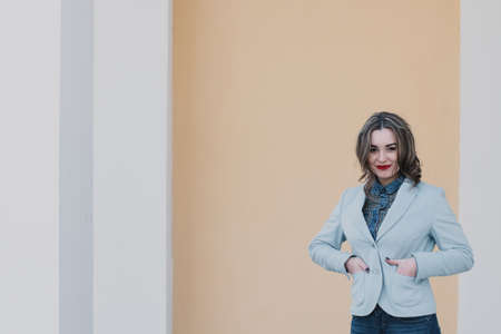 Portrait of a happy enamored girl in anticipation of a beloved man in the parkの写真素材