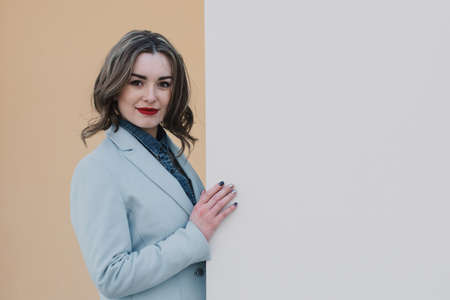 Portrait of a happy enamored girl in anticipation of a beloved man in the parkの写真素材