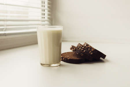 Bread with milk on a white window sill.の写真素材