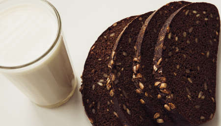 Bread with milk on a white window sill.の写真素材