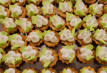 Many cakes in the form of flowers on the table.の写真素材