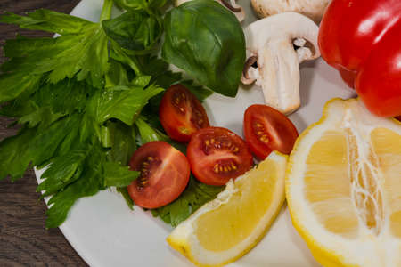 Parsley, lemon, pepper champignons on a plateの写真素材
