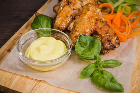 Fried chicken wings with sauce and salad.の写真素材