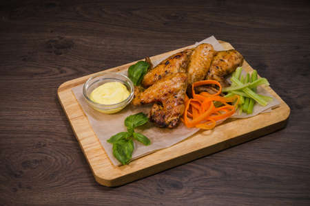 Fried chicken wings with sauce and salad.の写真素材