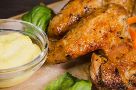 Fried chicken wings with sauce and salad.の写真素材