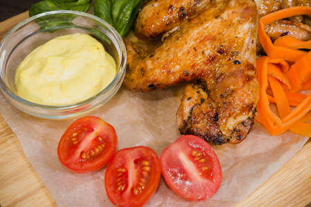 Fried chicken wings with sauce and salad.の写真素材