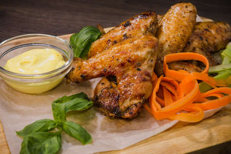 Fried chicken wings with sauce and salad.の写真素材