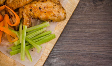 Fried chicken wings with sauce and salad.の写真素材
