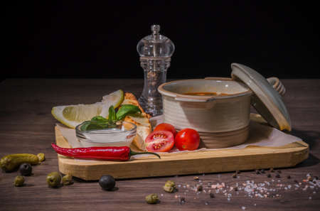 Soup on a wooden background with white bread and sauce.の写真素材