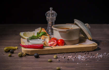 Soup on a wooden background with white bread and sauce.の写真素材