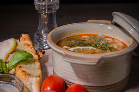 Soup on a wooden background with white bread and sauce.の写真素材