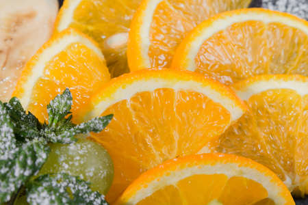 Fruit slicing on a wooden background and on a stone stand.の写真素材