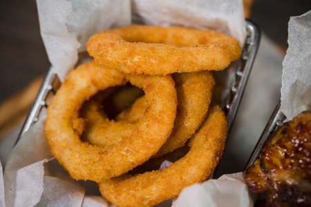 Snack for beer in the form of nuggets cheese rings and fried chicken legs.の写真素材