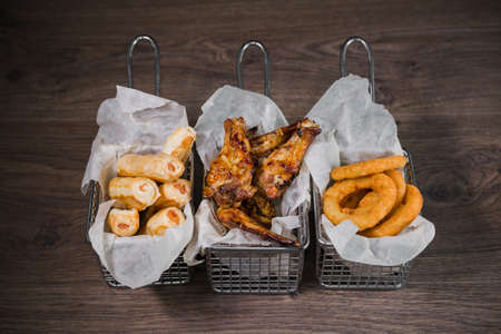 Snack for beer in the form of nuggets cheese rings and fried chicken legs.の写真素材